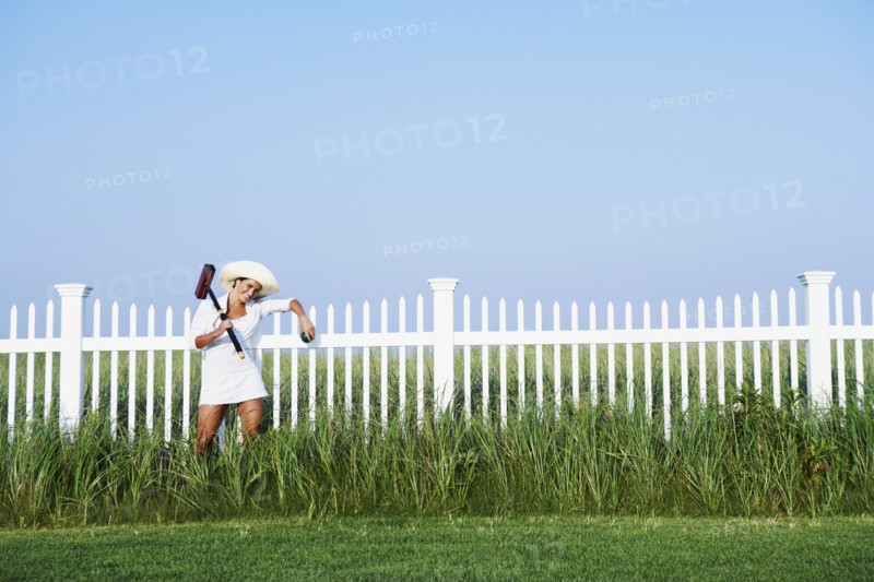 Hispanic woman holding croquet mallet