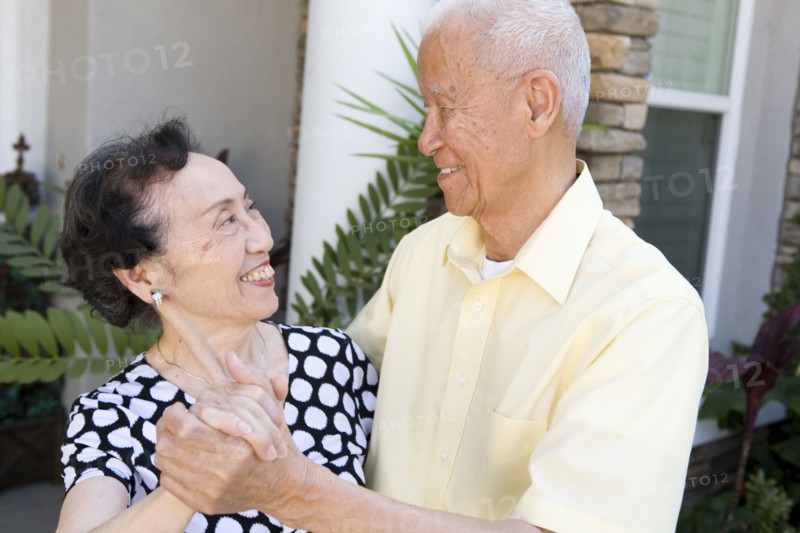 Senior Chinese couple dancing outdoors