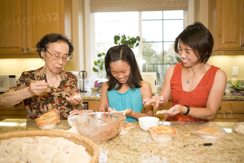 Multi-generation Chinese family cooking together