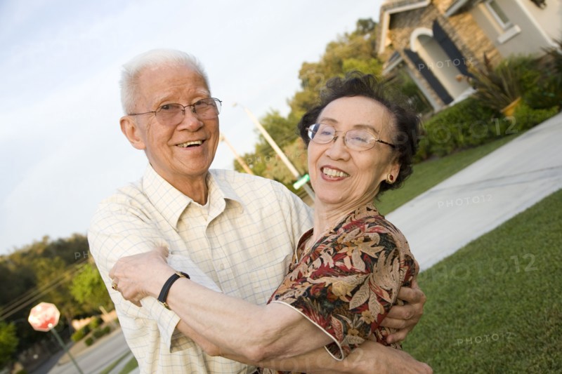 Senior Chinese couple hugging outdoors