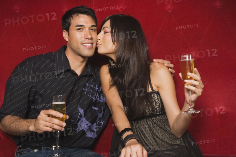 Middle Eastern woman kissing boyfriend's cheek
