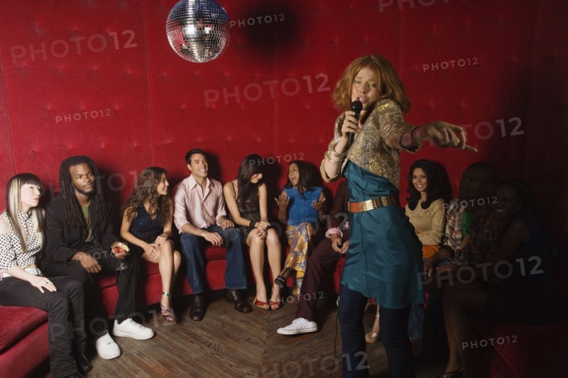 Woman singing karaoke at nightclub