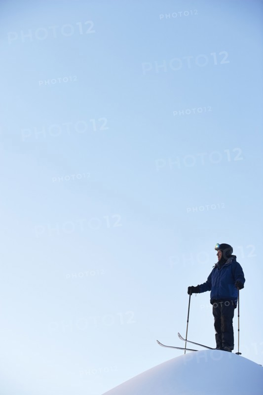 Caucasian skier on hilltop