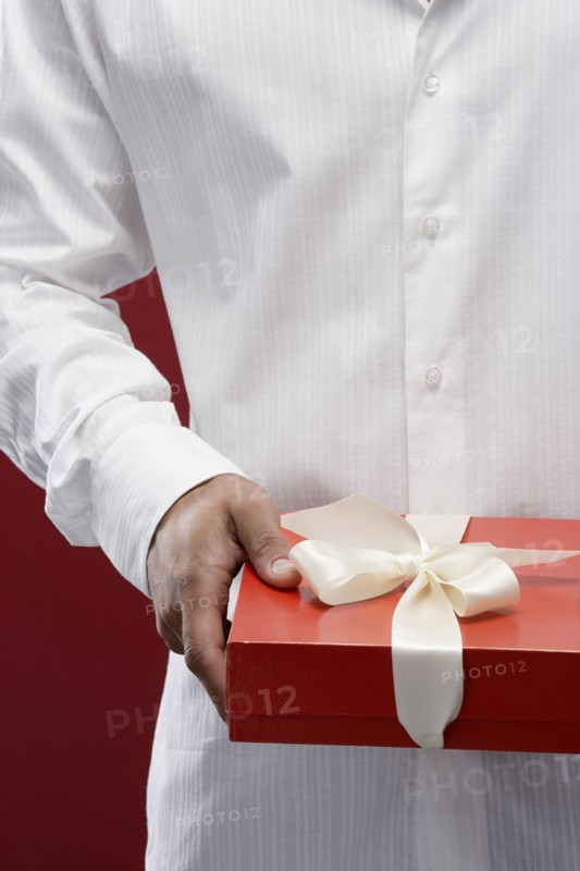 Mixed race man holding wrapped gift