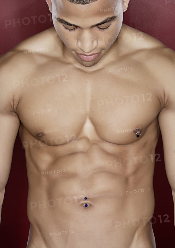 Mixed race man flexing abdominal muscles
