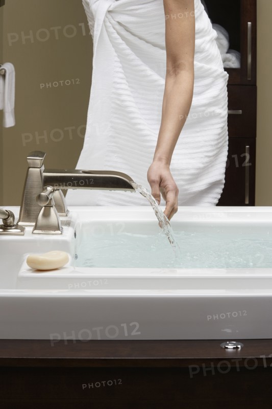 Caucasian woman running bath