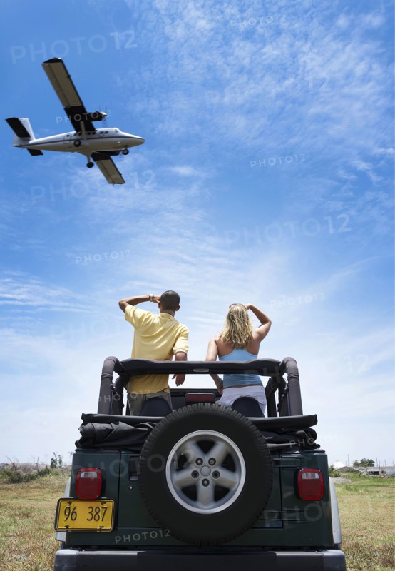Couple admiring plane from 4x4