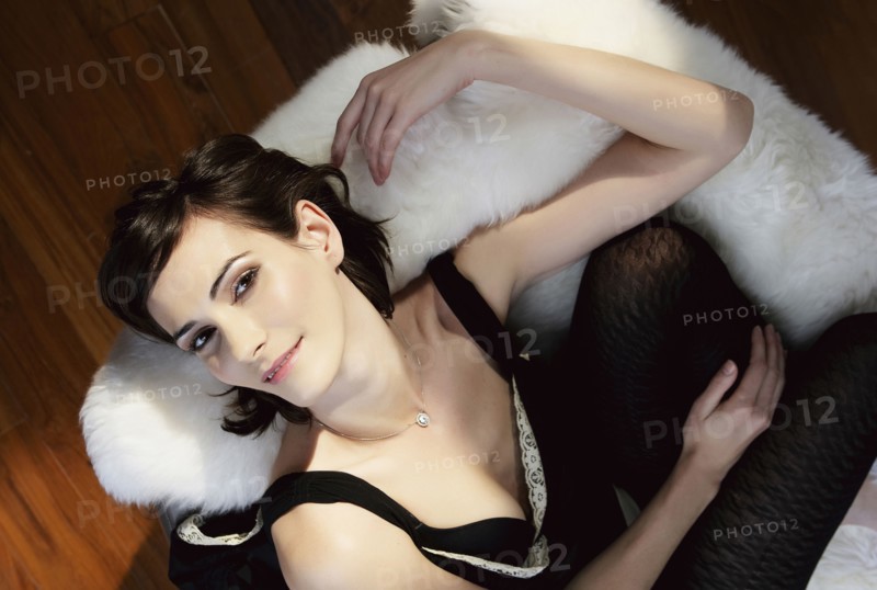 Caucasian woman laying on shag rug