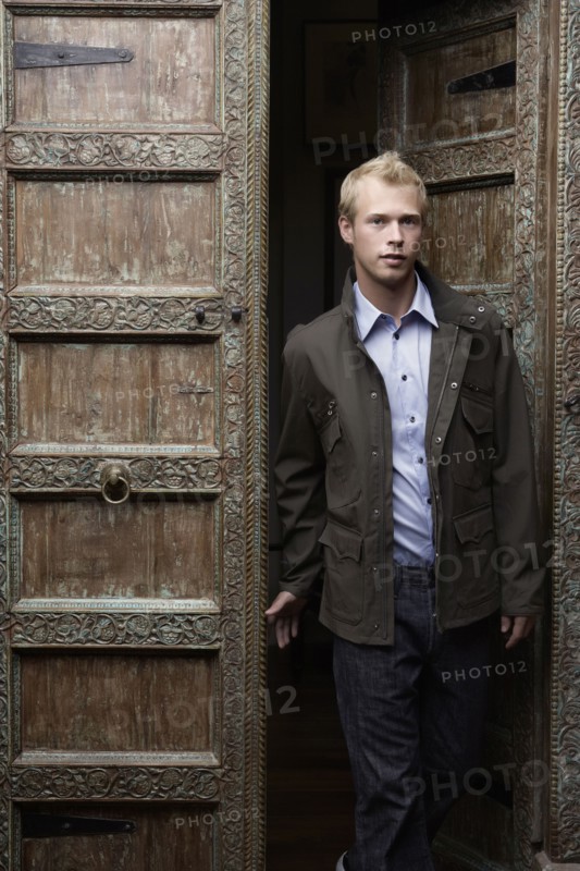 Caucasian man standing in ornate doorway