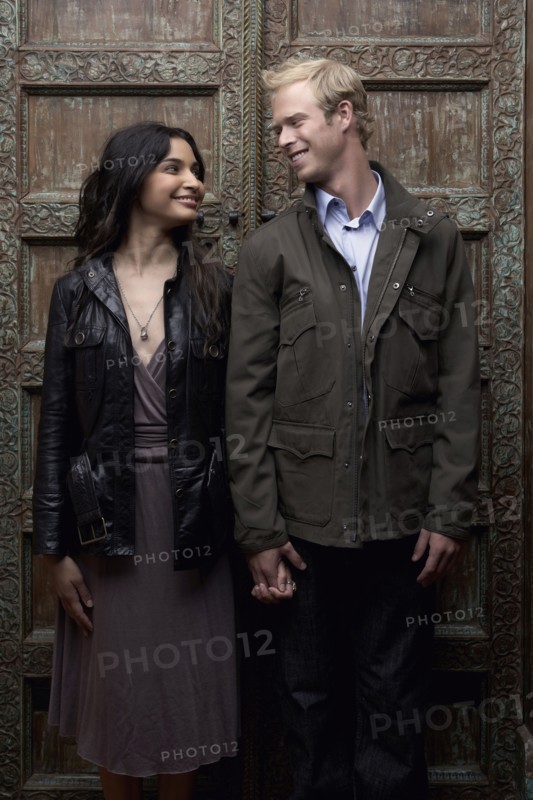 Couple holding hands in ornate doorway