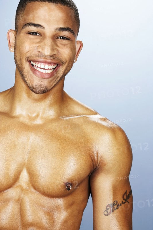 Bare chested mixed race man smiling
