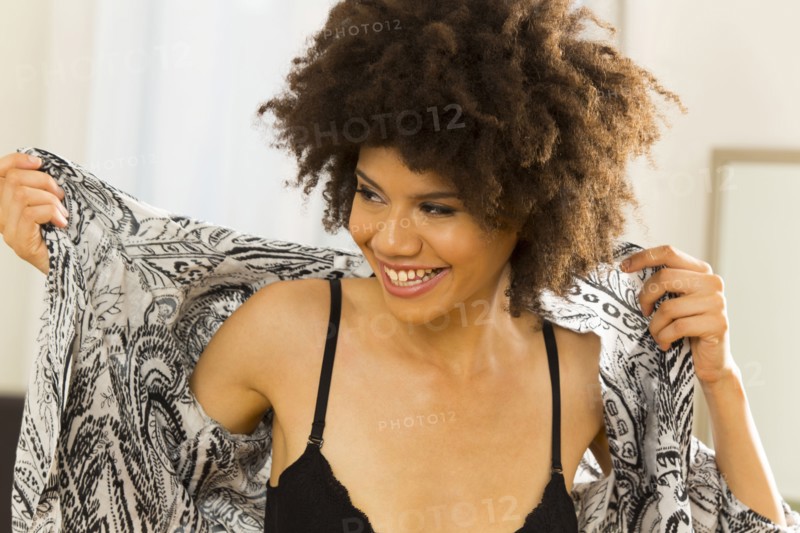Mixed race woman getting dressed