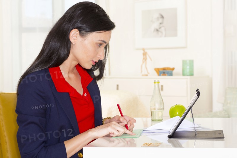Mixed race businesswoman working at desk
