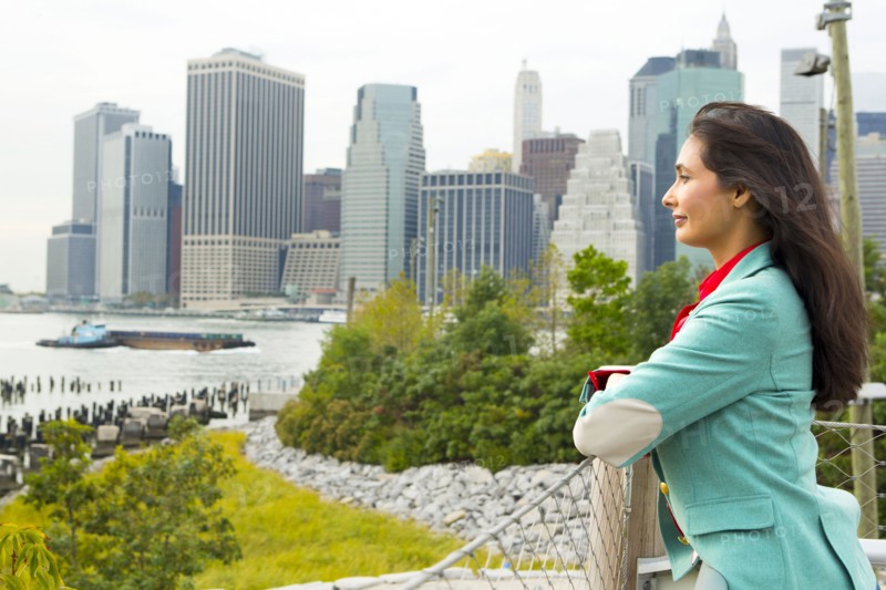 Mixed race woman overlooking park and river