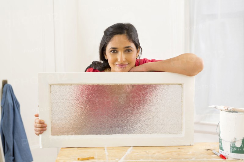 Mixed race woman making window pane