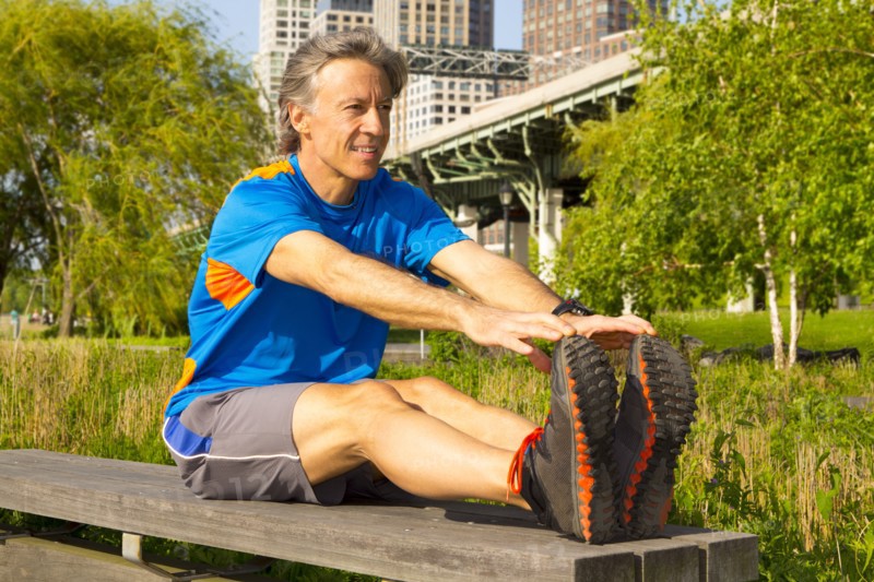 Caucasian man stretching in urban park