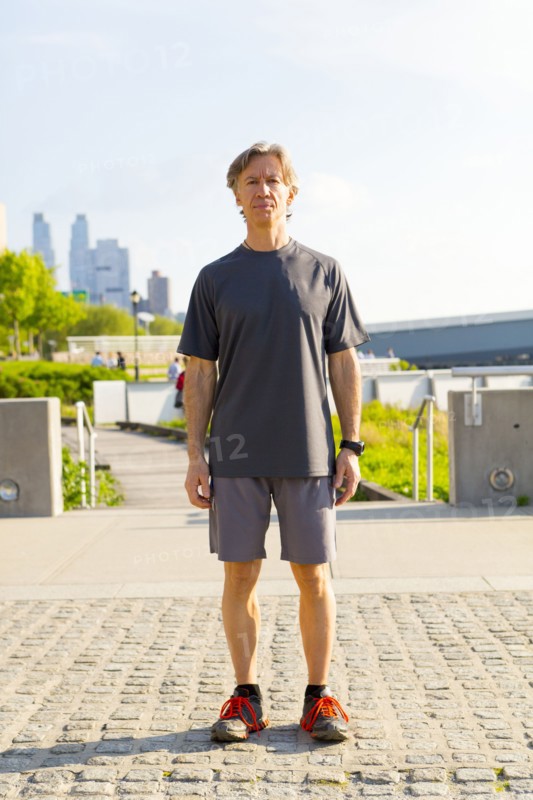 Caucasian runner standing in urban park