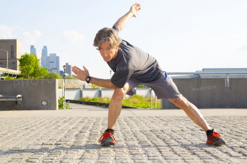 Caucasian man stretching in urban park