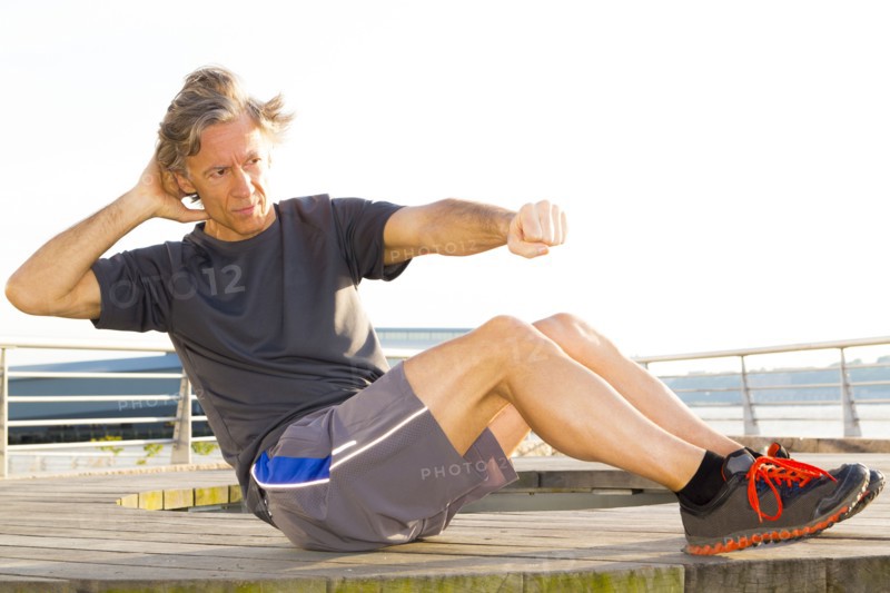 Caucasian man exercising in waterfront park