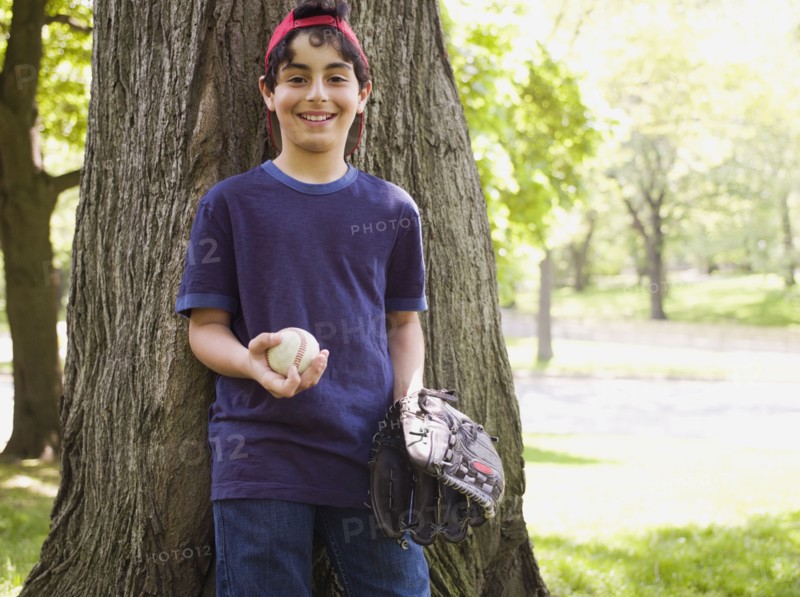 Smiling mixed race boy holding baseball and glove