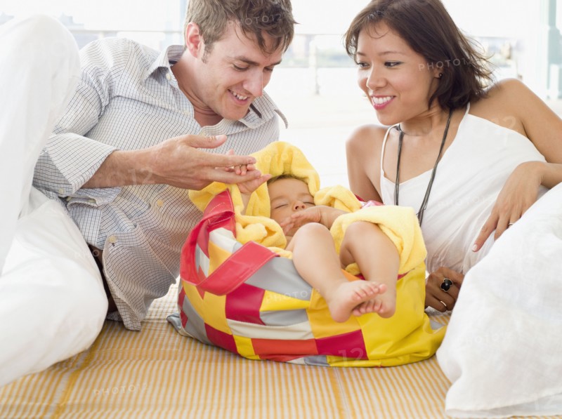Proud parents looking at sleeping daughter
