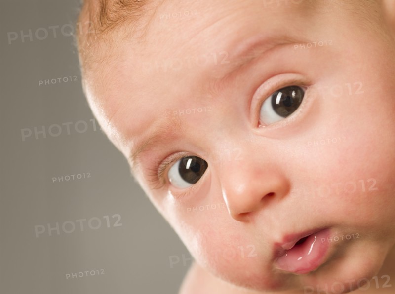 Curious mixed race newborn baby