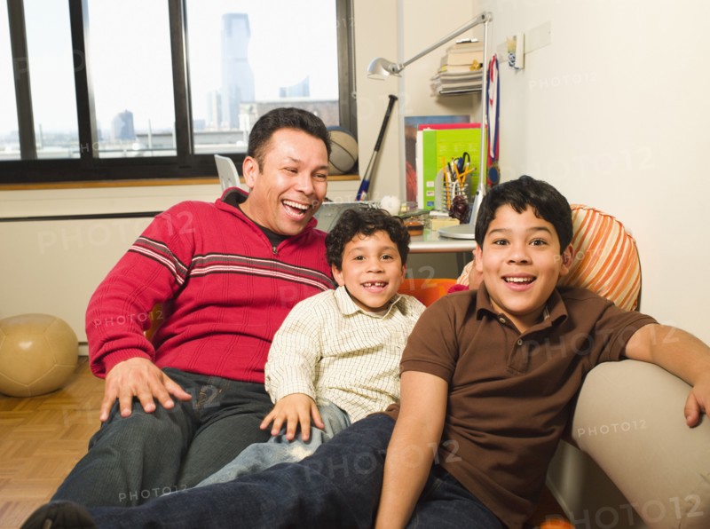 Hispanic father and sons laughing