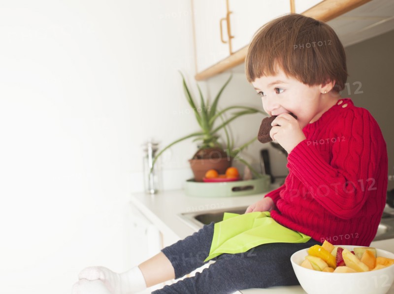 Mixed race boy eating brownie