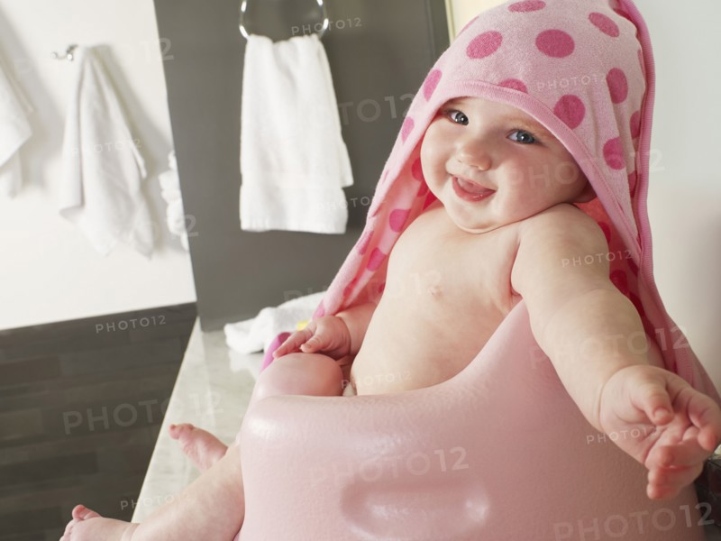 Caucasian baby girl siting in high chair