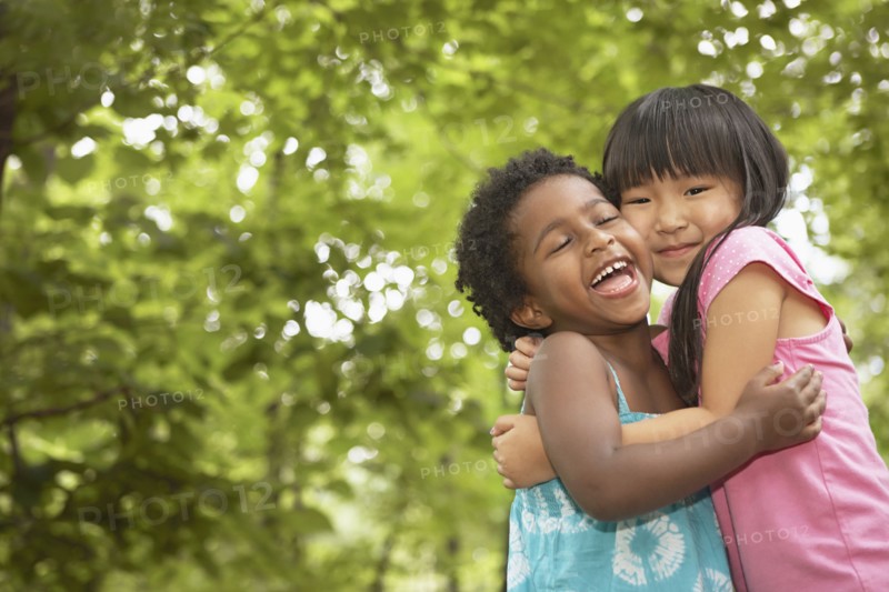 Girls hugging outdoors