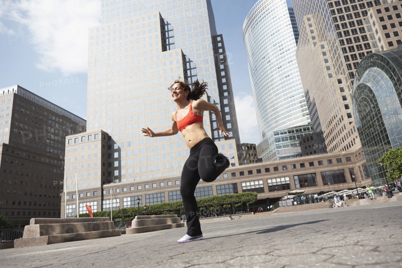 Mixed race woman working out on city street
