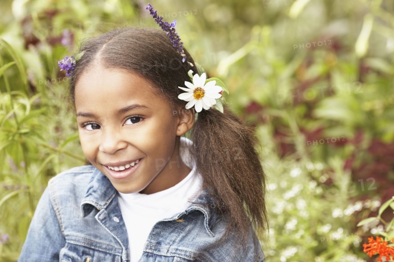 Mixed race girl wearing flowers in her hair