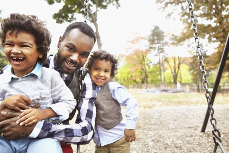 Father and sons playing together in park