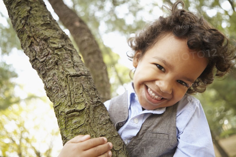 Mixed race boy smiling in park