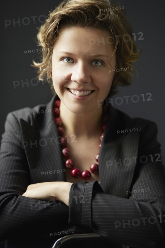 Smiling businesswoman posing in studio
