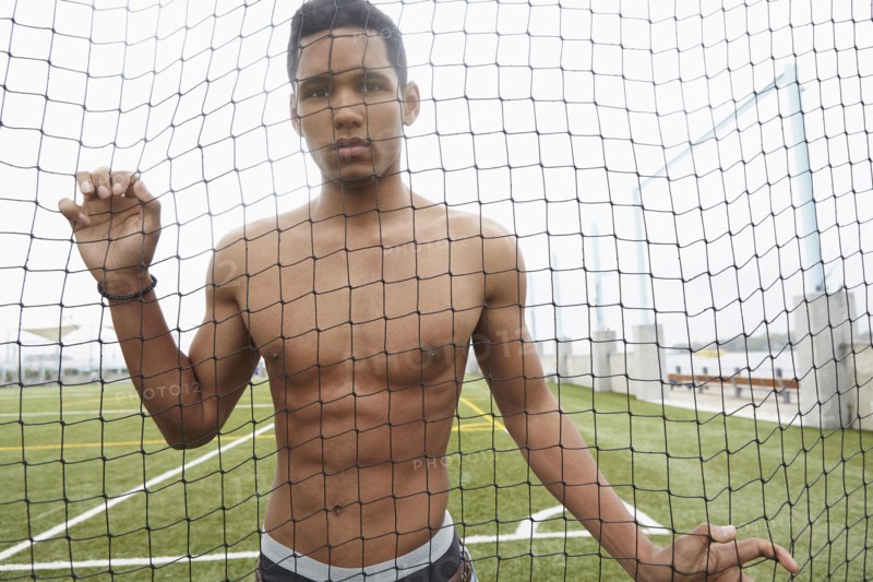 Man standing in soccer net on field