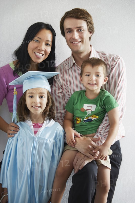Family with graduating daughter smiling together