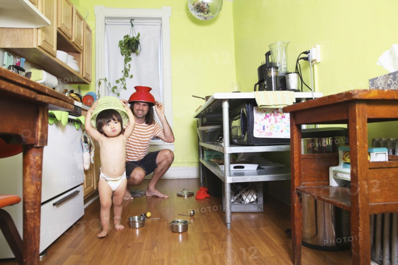 Father and daughter playing in kitchen