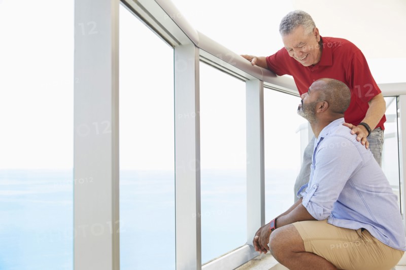 Father and son standing on balcony