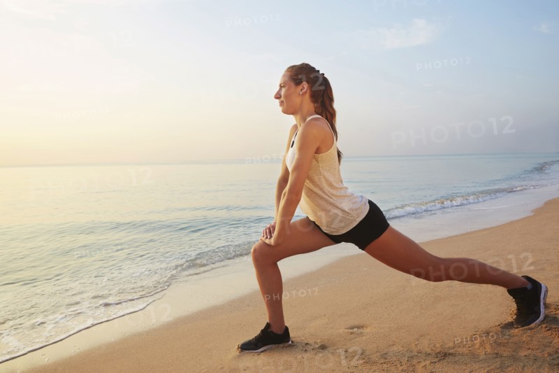 Athlete stretching on beach