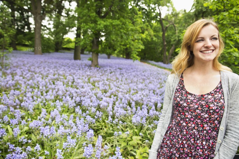 Caucasian woman smiling in field of flowers