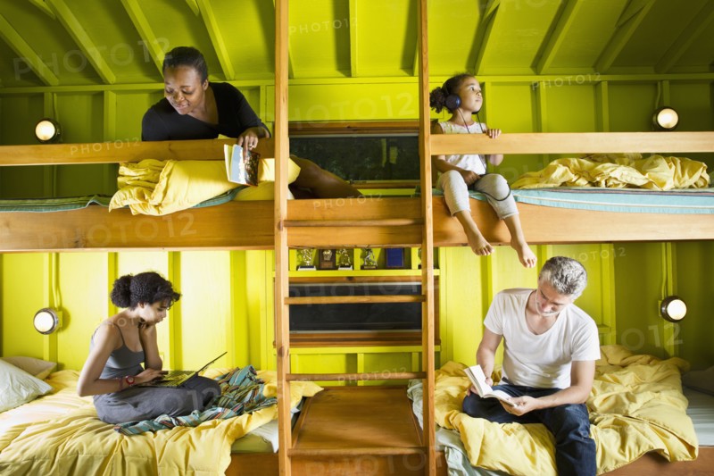 Family relaxing in bunk beds at camp