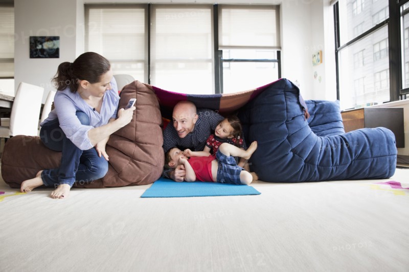 Family playing in blanket fort