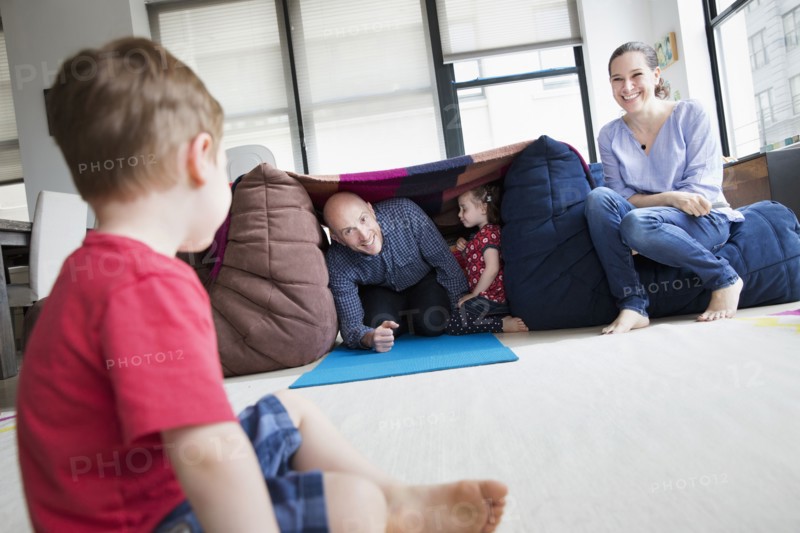Family playing in blanket fort