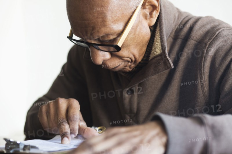Older Black man reading notes