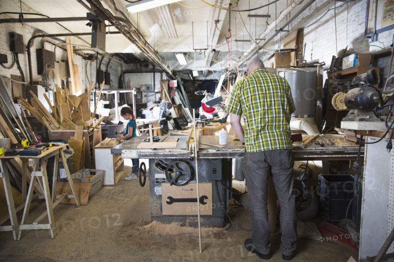 Father and daughter woodworking in workshop