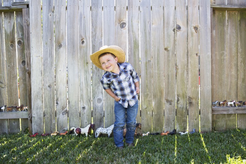 Caucasian boy wearing cowboy hat smiling
