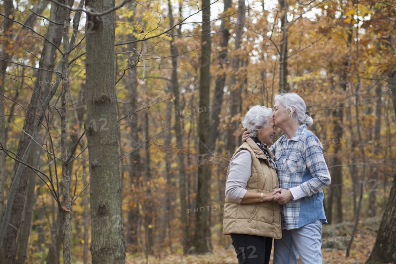 Caucasian women kissing outdoors in autumn