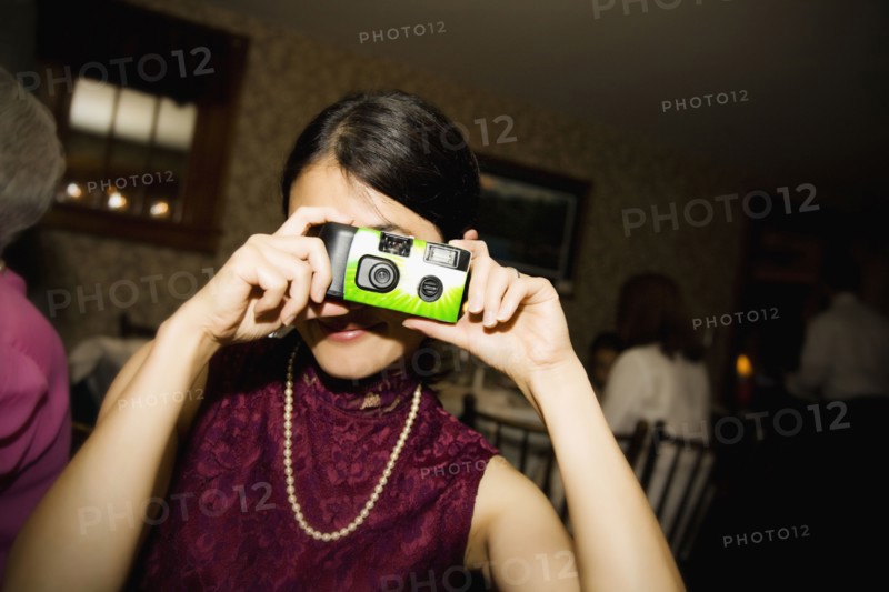 Asian woman taking photograph