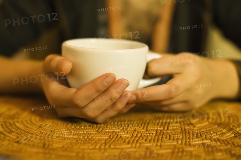 Close up of woman's hands holding tea mug